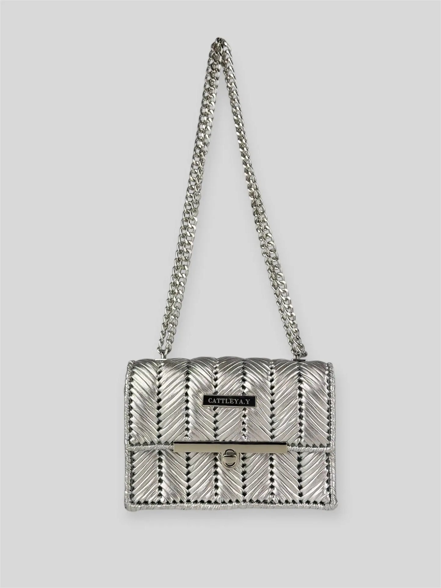 Brilliant Silver is a luxury handmade mini designer bag by CATTLEYA.Y, defined by its luminous metallic finish and refined chevron texture. The cool silver tone reflects light effortlessly, creating a striking yet sophisticated presence.