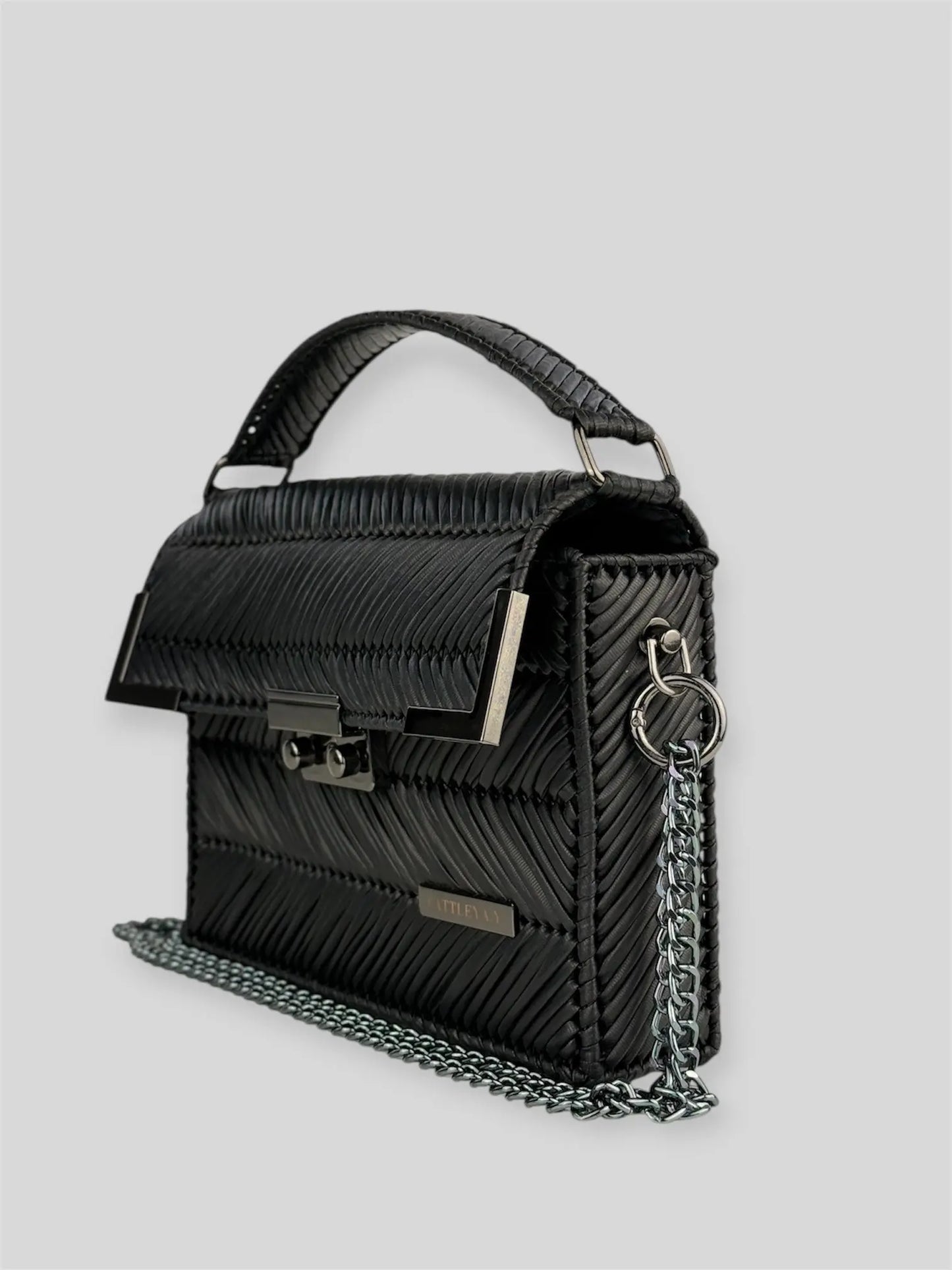 Amara Dark Brown is a luxury handmade designer bag by CATTLEYA.Y, distinguished by its rich chocolate tone and signature chevron texture. Timeless, structured and refined, it embodies quiet confidence and modern elegance.
Amara Black structured black handbag with top handle