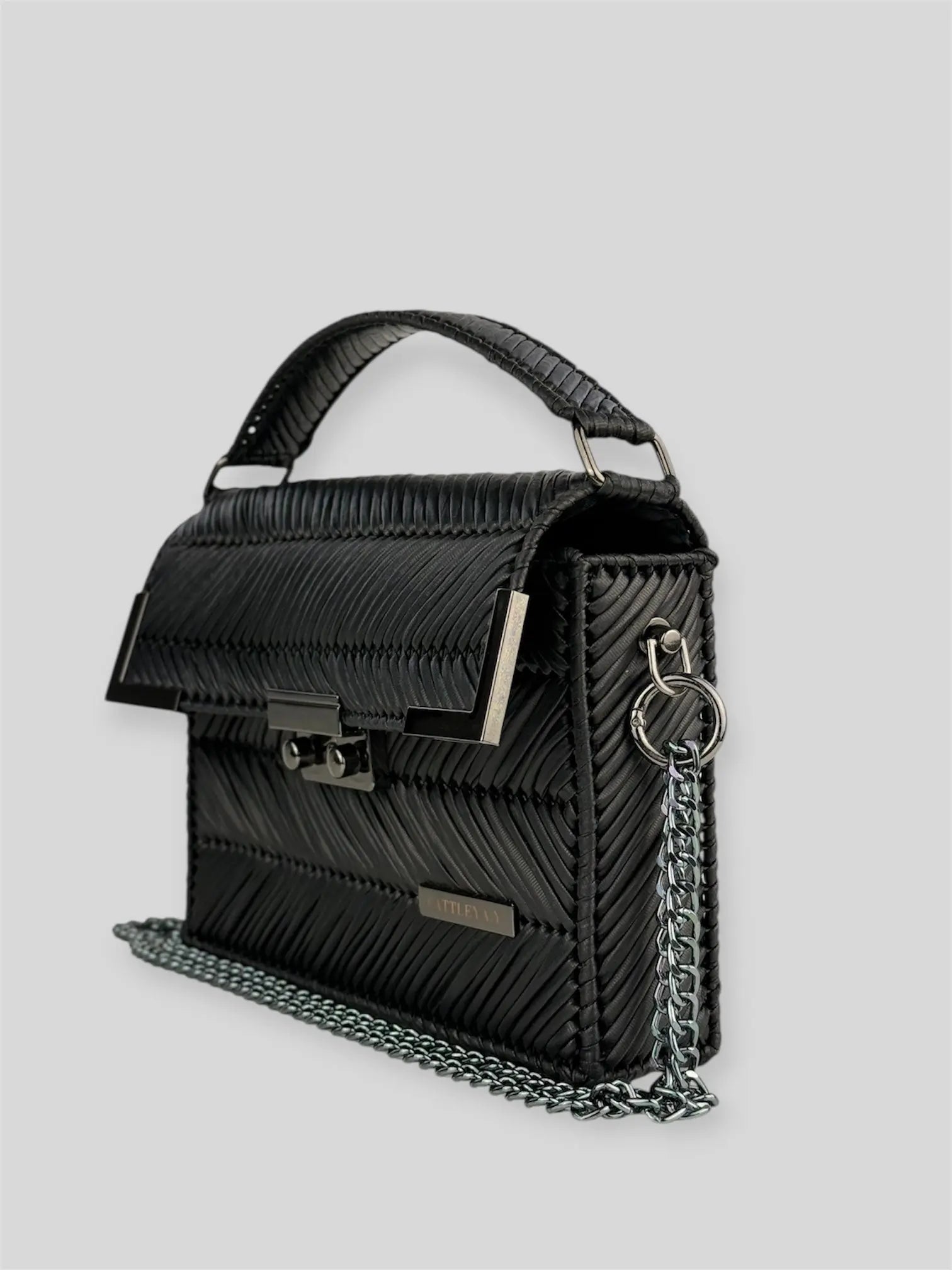 Amara Dark Brown is a luxury handmade designer bag by CATTLEYA.Y, distinguished by its rich chocolate tone and signature chevron texture. Timeless, structured and refined, it embodies quiet confidence and modern elegance.
Amara Black structured black handbag with top handle