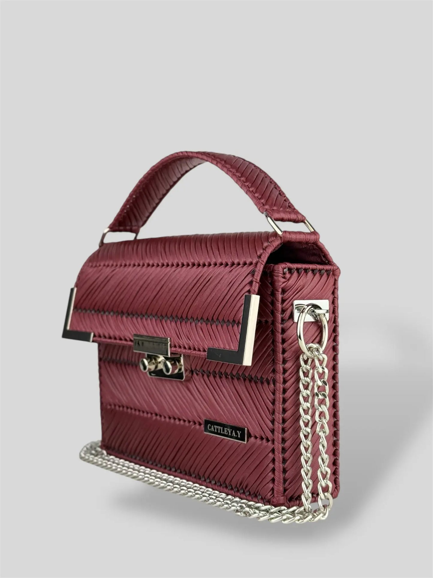 Amara Burgundy is a luxury handmade designer bag by CATTLEYA.Y, distinguished by its rich wine-red tone and refined chevron texture. Elegant yet bold, it captures timeless femininity with a contemporary edge.
Amara Burgundy structured wine red handbag with silver clasp