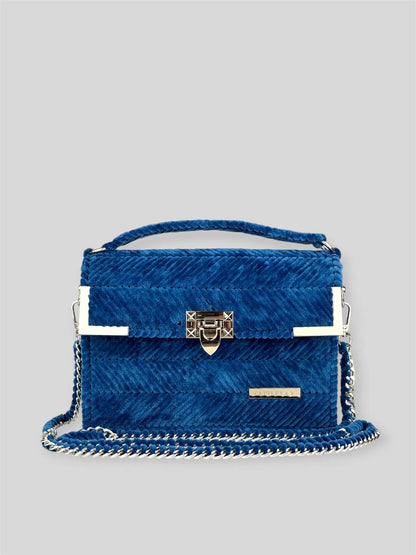 Amara Winter Blue is a luxury handmade designer bag by CATTLEYA.Y, defined by its deep blue tone and refined chevron texture. The structured silhouette creates a polished presence suitable for both elevated everyday wear and evening styling.