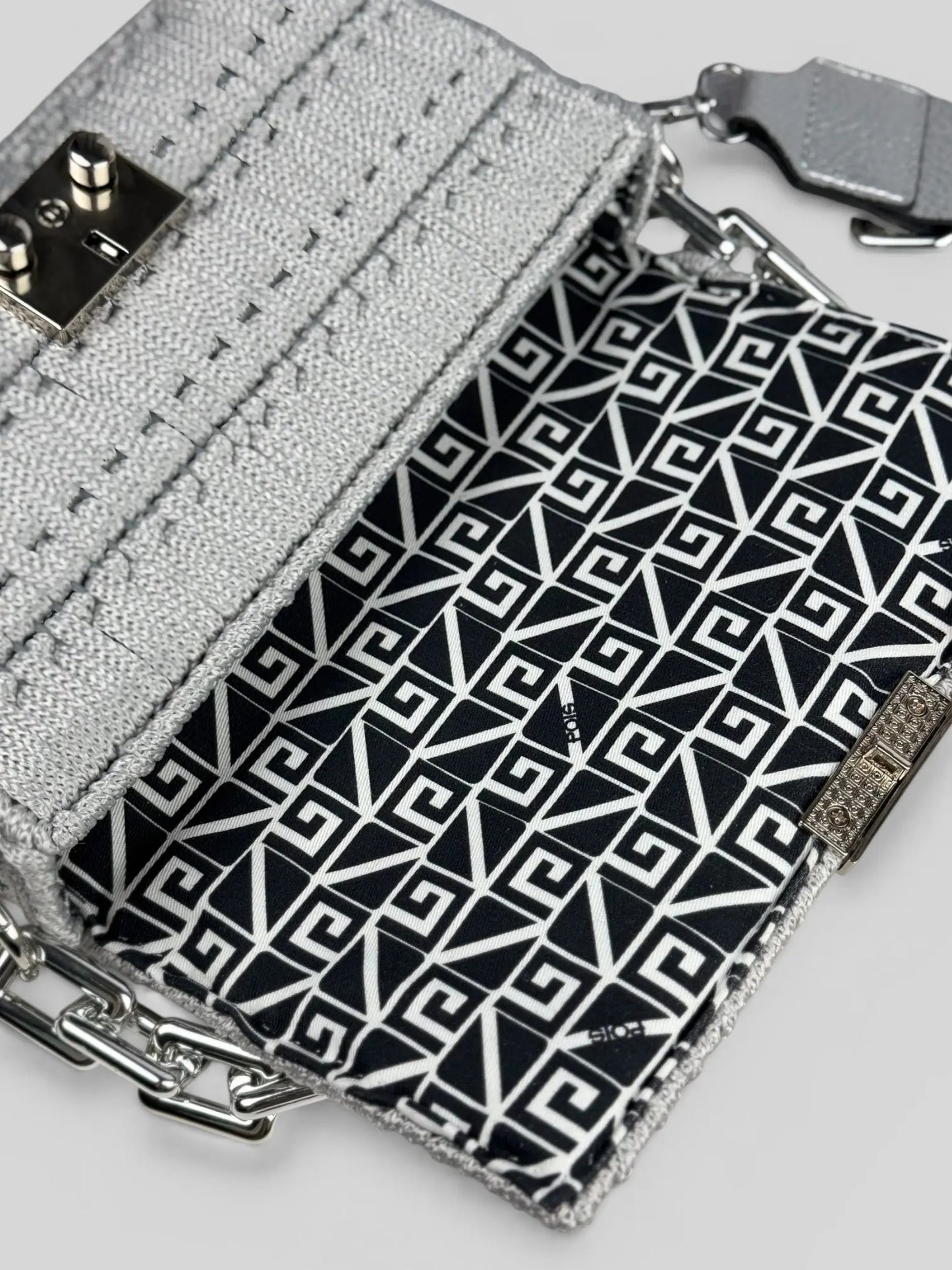 Aurora Silver is a luxury handmade macrame designer bag. The interior has a geometric lining detail.