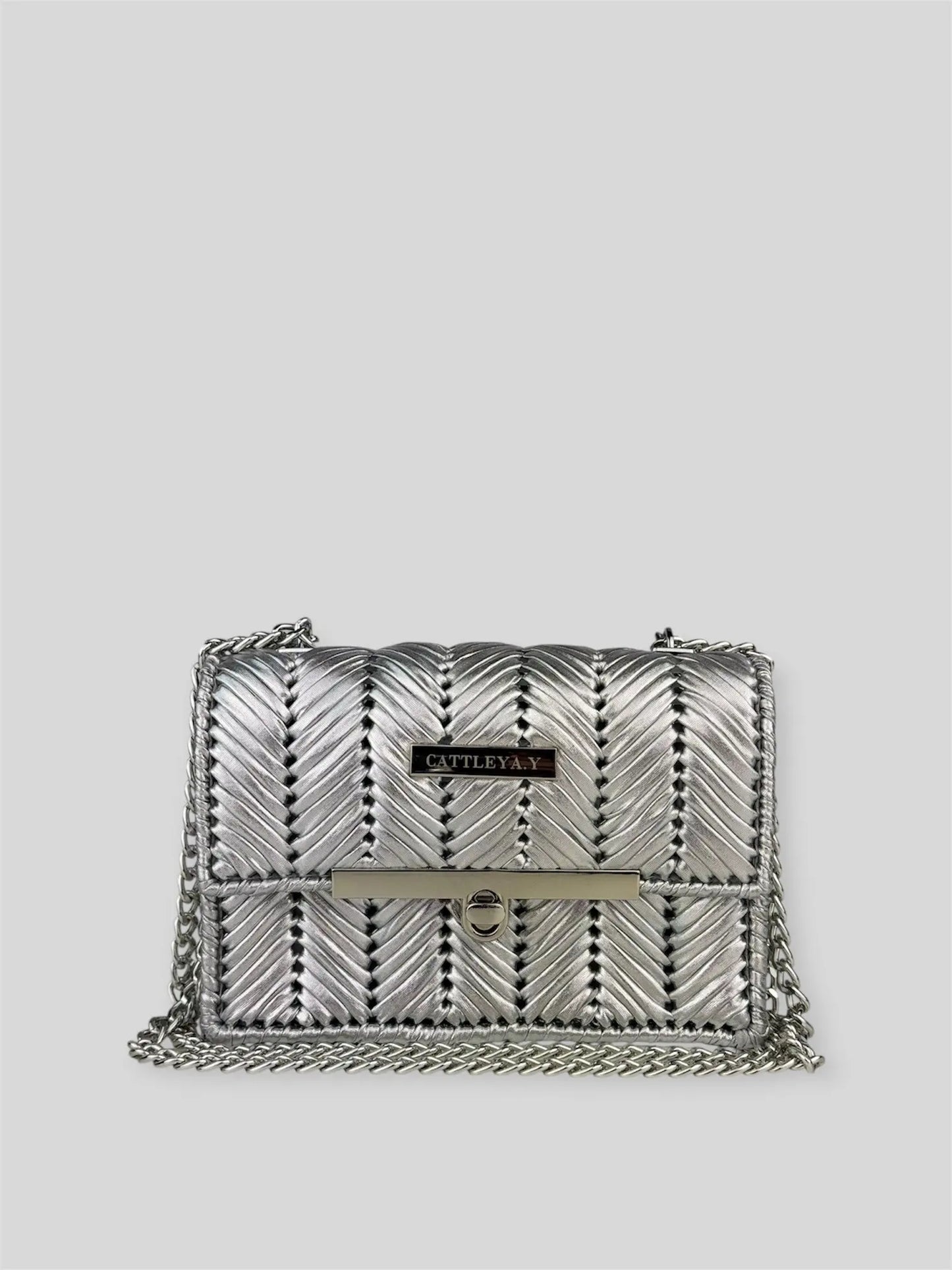 Brilliant Silver is a luxury handmade mini designer bag by CATTLEYA.Y, defined by its luminous metallic finish and refined chevron texture. The cool silver tone reflects light effortlessly, creating a striking yet sophisticated presence.
Brilliant Silver metallic chevron mini designer bag CATTLEYA.Y