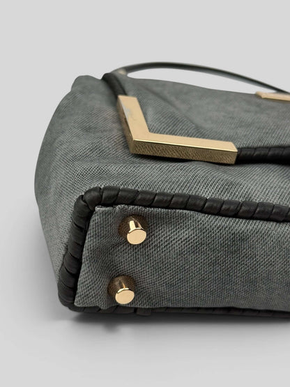 Bottom detail of Denim Graphite bag with gold studs and black accents. Denim Graphite is a Luxury Handmade Designer Bag by CATTLEYA.Y