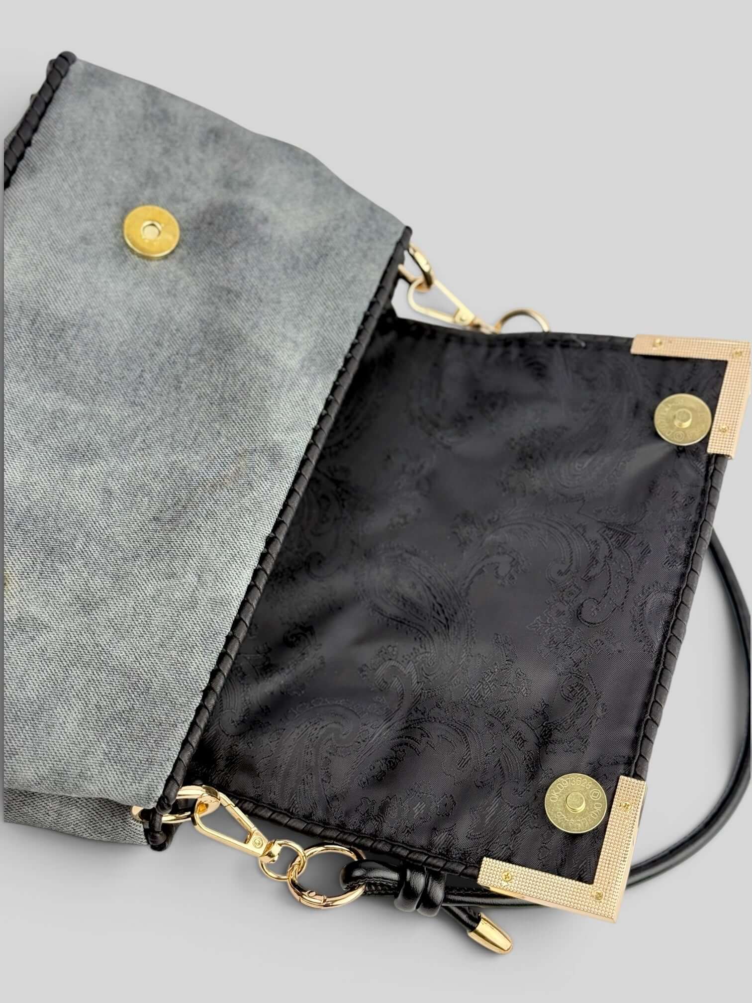 Interior of Denim Graphite handbag with black lining and magnetic closure.
Denis Graphite is luxury handmade designer bag by CATTLEYA.Y
