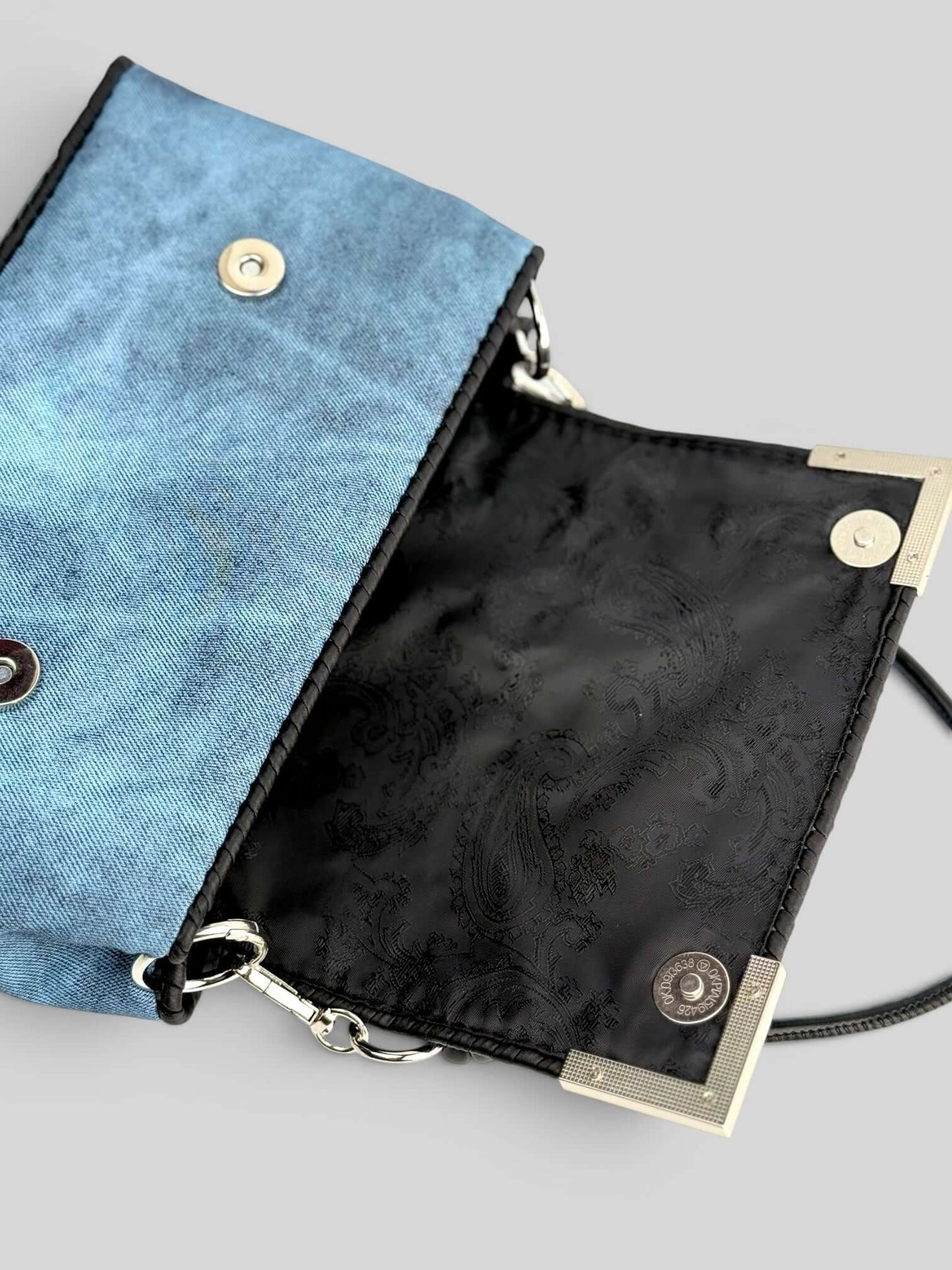 Denim Sky bag interior detail with black lining.
Denim Pink is a luxury handmade designer bag by CATTLEYA.Y
