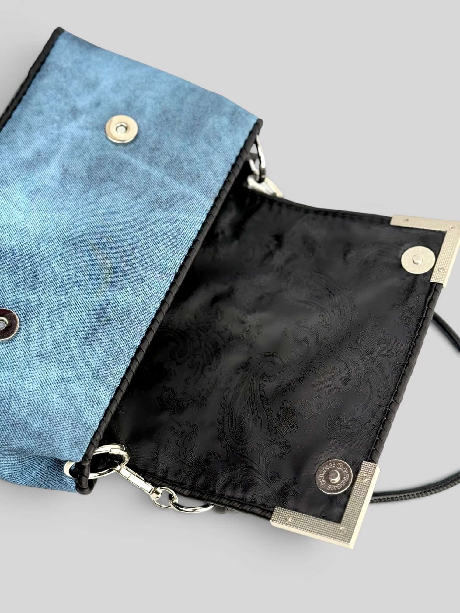 Denim Sky bag interior detail with black lining.
Denim Pink is a luxury handmade designer bag by CATTLEYA.Y