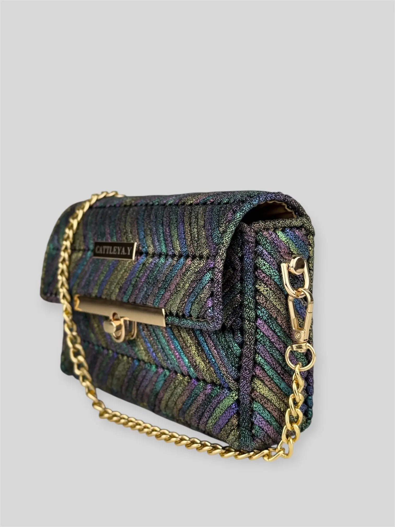 Mermaid Deep Aura is a luxury handmade designer bag by CATTLEYA.Y, inspired by shifting ocean hues and luminous textures. The iridescent multicolor yarn creates a dynamic surface that reflects light from every angle.
Mermaid Deep Aura multicolor geometric evening handbag side view