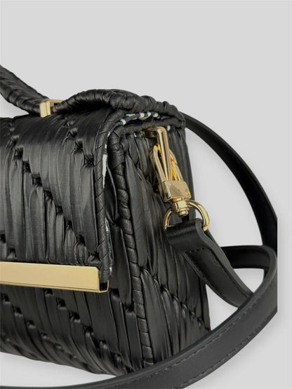 Noir is a luxury handmade designer bag by CATTLEYA.Y, defined by its deep black tone and architectural silhouette. Designed for women who embrace modern minimalism, it delivers powerful elegance with refined restraint.
Noir black textured handbag with gold-tone accent