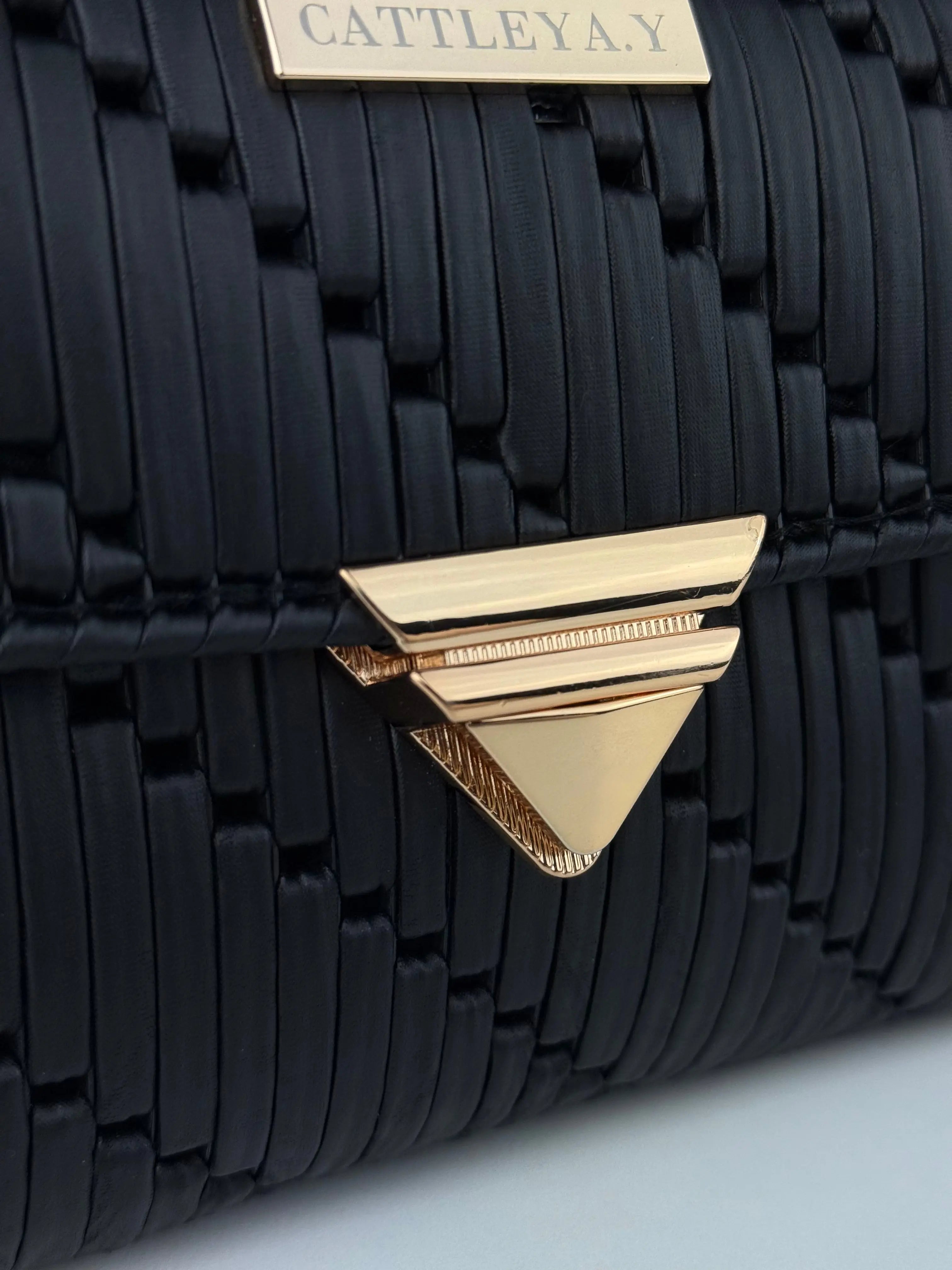 Tiffany is a black luxury handmade designer bag with gold triangular clasp by CATTLEYA.Y
