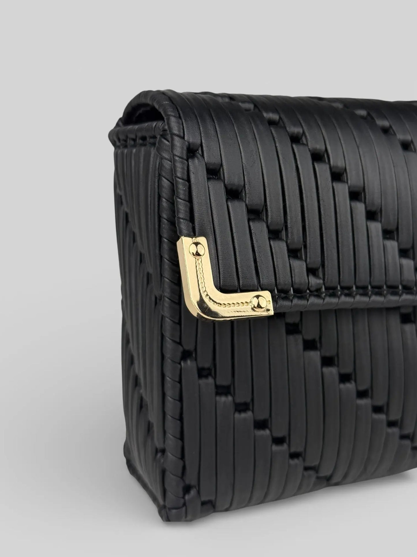 Tiffany  is a black luxury handmade designer bag with a gold corner hardware detail by CATTLEYA.Y