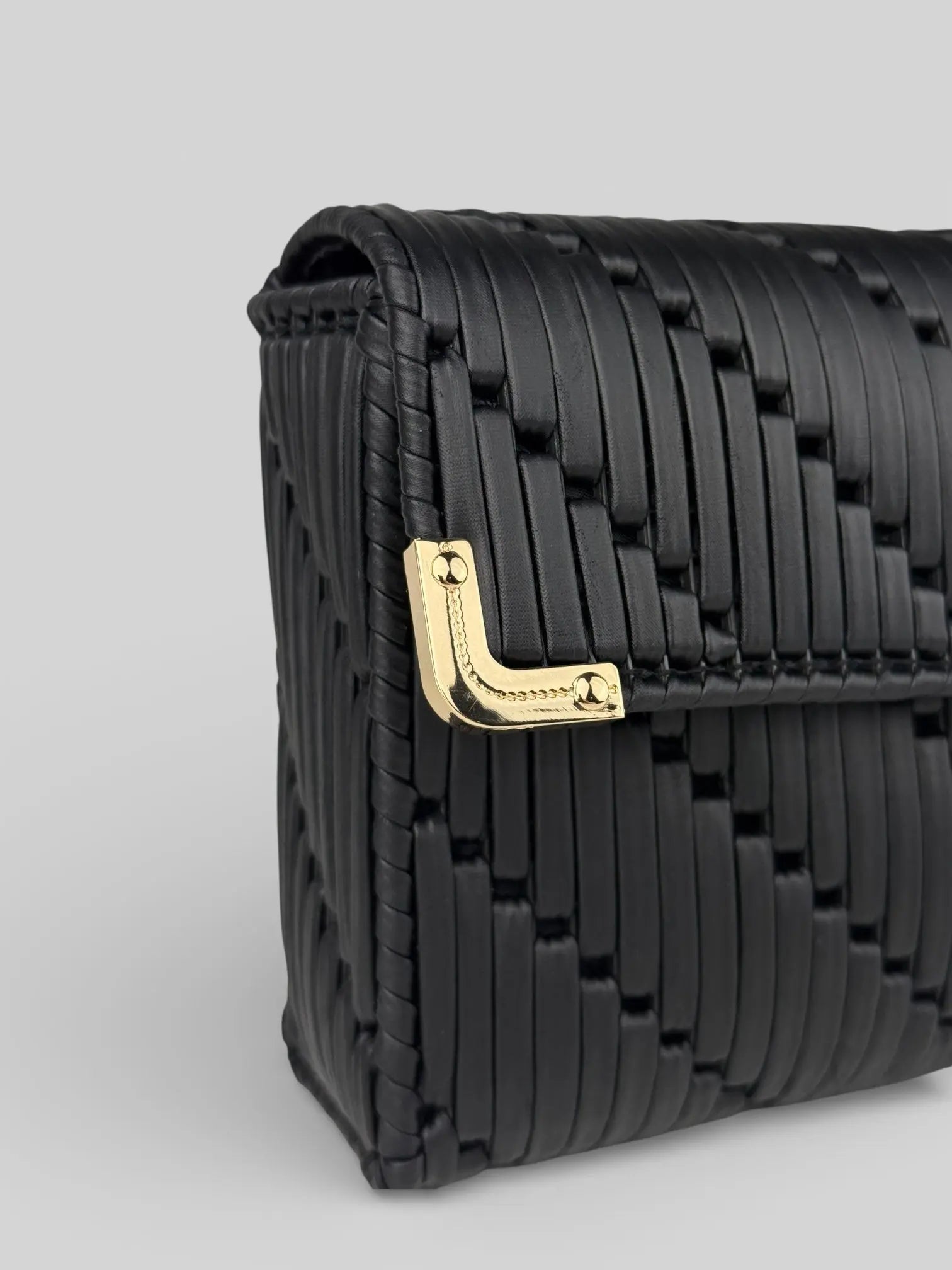 Tiffany  is a black luxury handmade designer bag with a gold corner hardware detail by CATTLEYA.Y