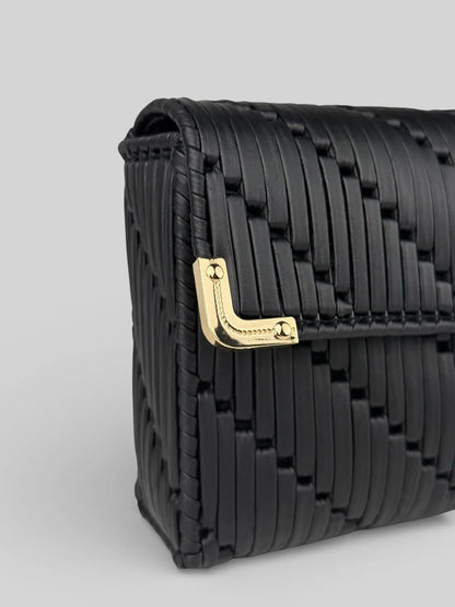 Tiffany  is a black luxury handmade designer bag with a gold corner hardware detail by CATTLEYA.Y