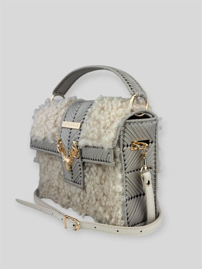 Vivian is a luxury handmade designer bag by CATTLEYA.Y, created for women who appreciate refined winter elegance. The combination of eco-leather yarn and soft bouclé texture creates depth, contrast and sophisticated character.
Vivian bouclé eco-leather handmade handbag with deer accent
